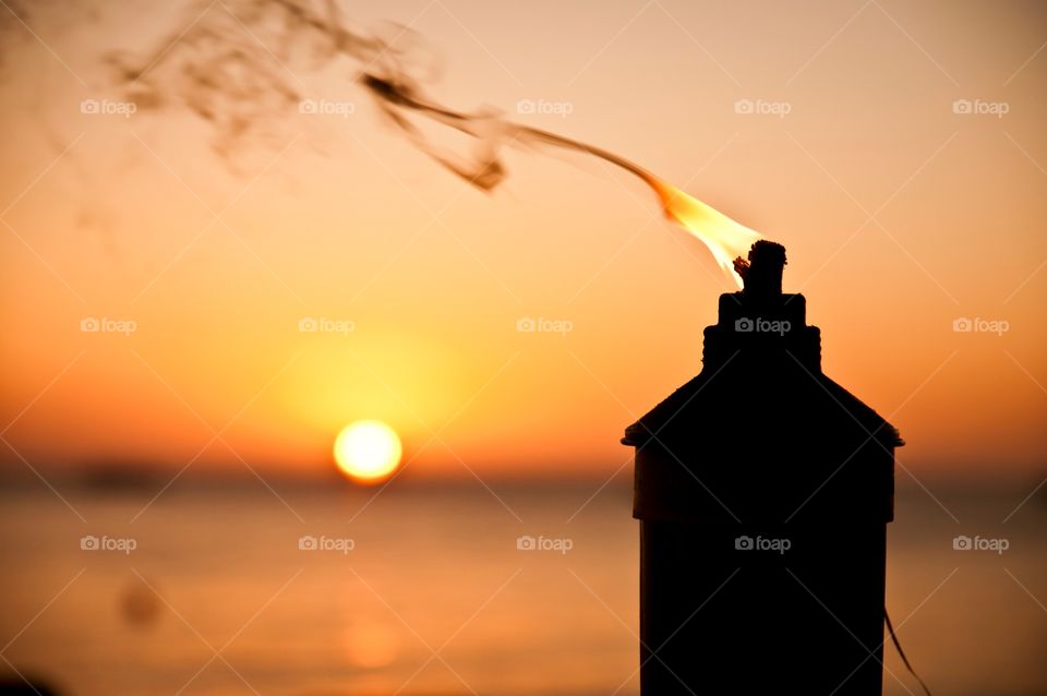 Tiki Torch waving in the sunset 