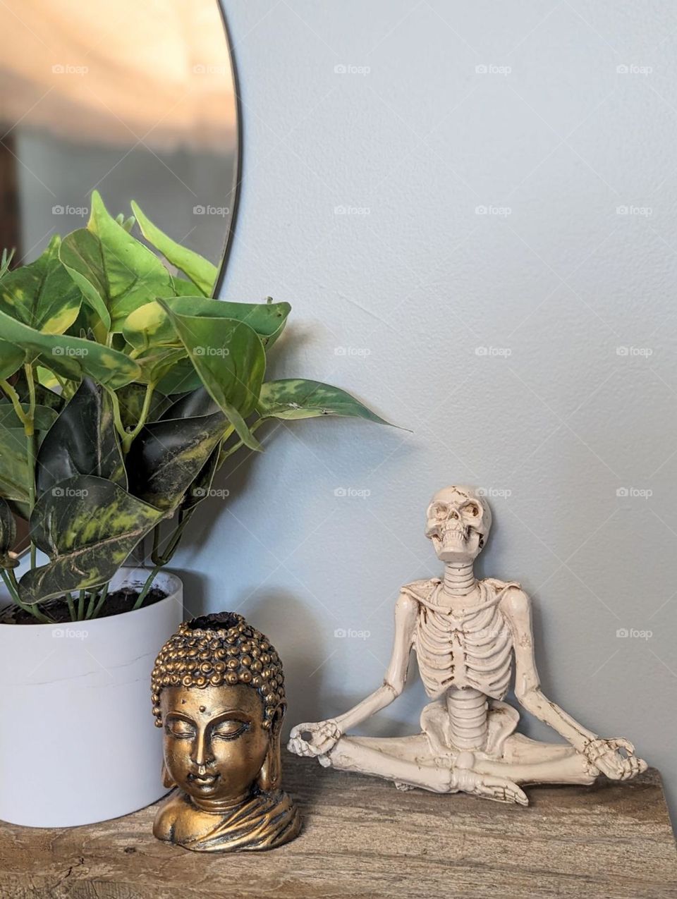 yoga room decor meditating skeleton with budda incense holder and fake green leaf plant