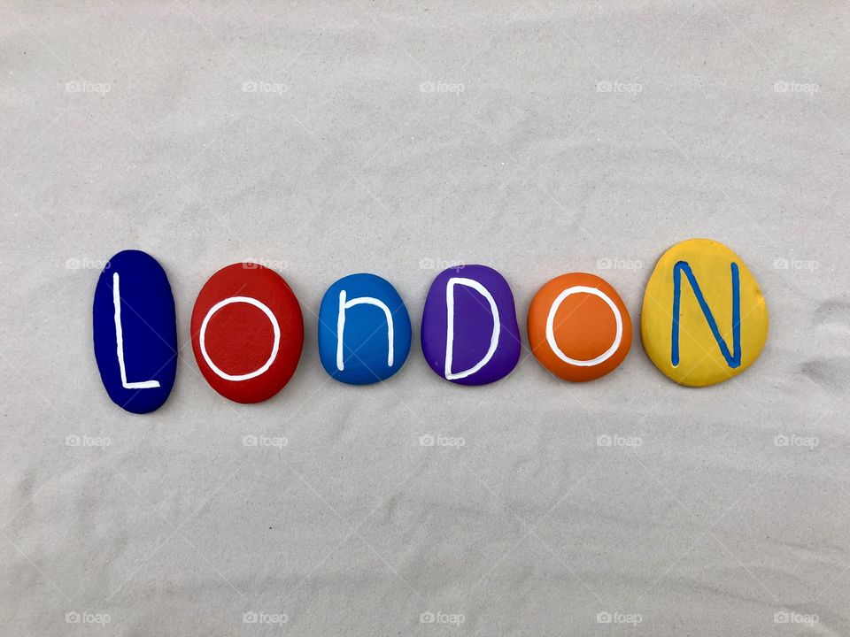 London city, England, souvenir with a composition of colored sea stones over white sand