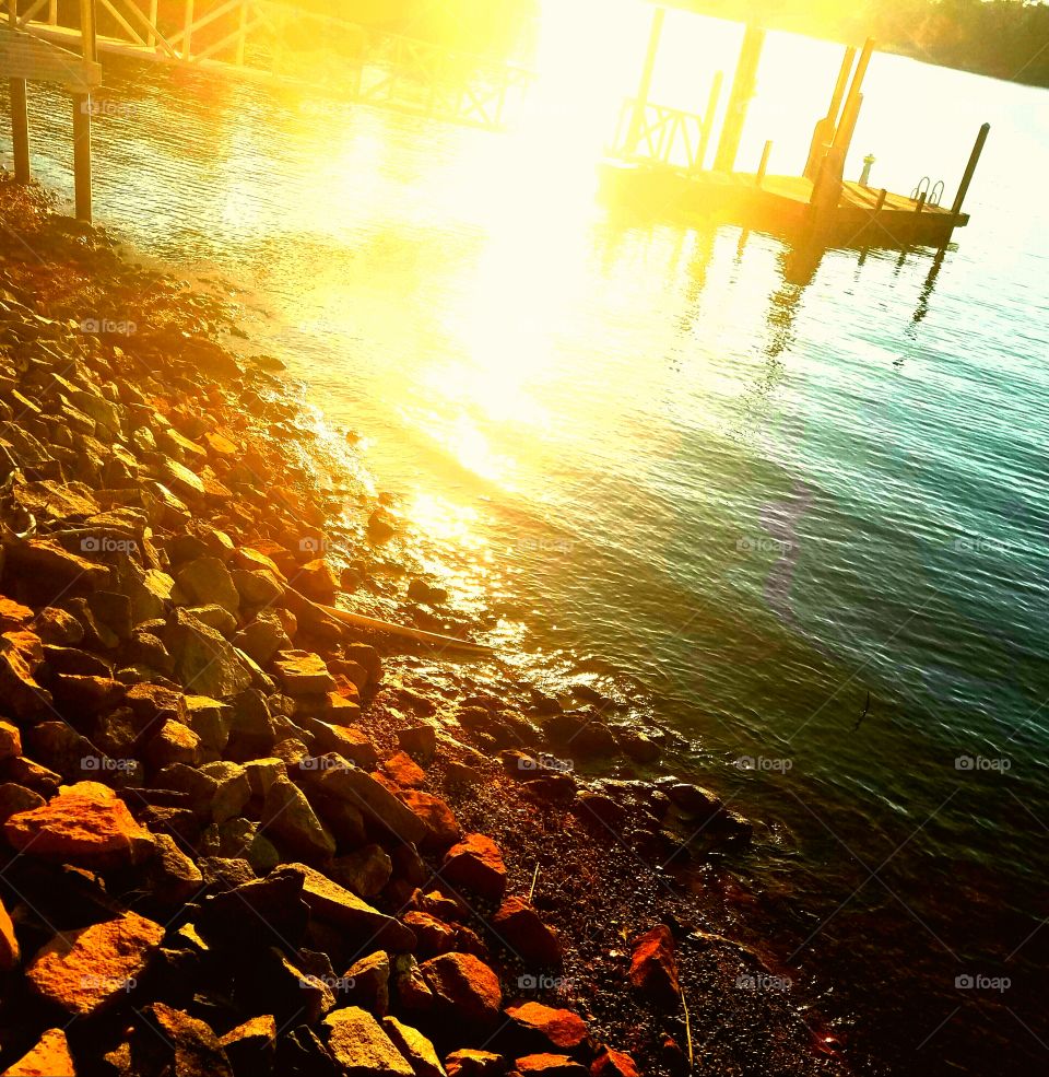 Sunrise reflecting off the lake by dock