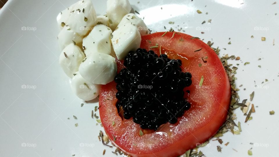 Caprese with shaved herbs, fresh mozzarella and balsamic caviar.