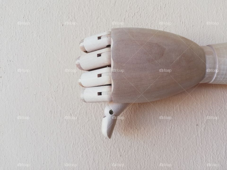 Wooden hand with thumb towards