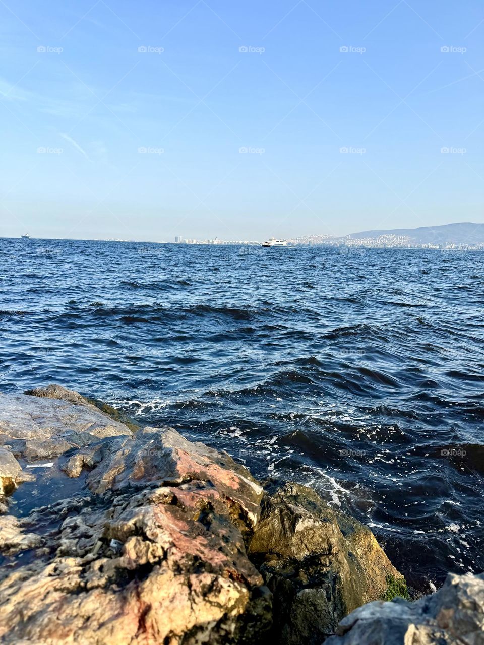 Sea water washing the rocks near the shore