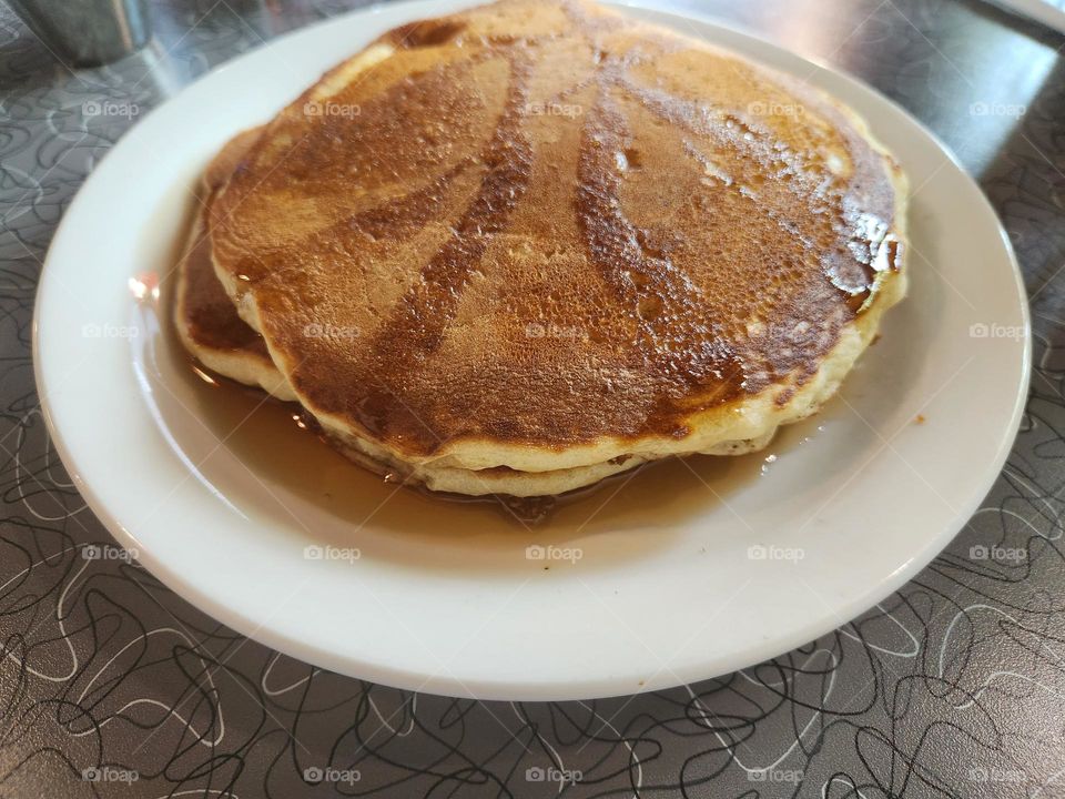 delicious golden pancake stack breakfast plate with syrup in Oregon restaurant