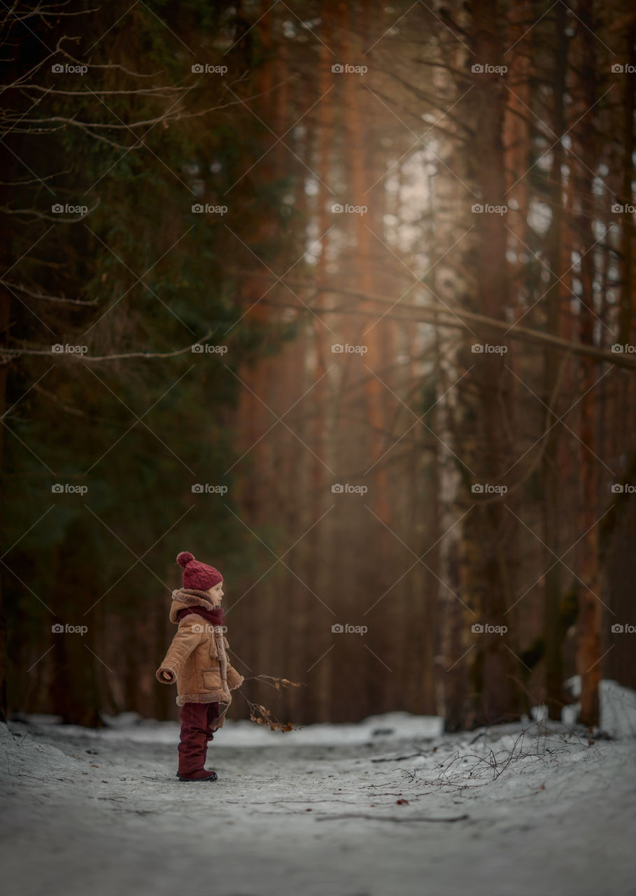 Little girl portrait at early spring forest