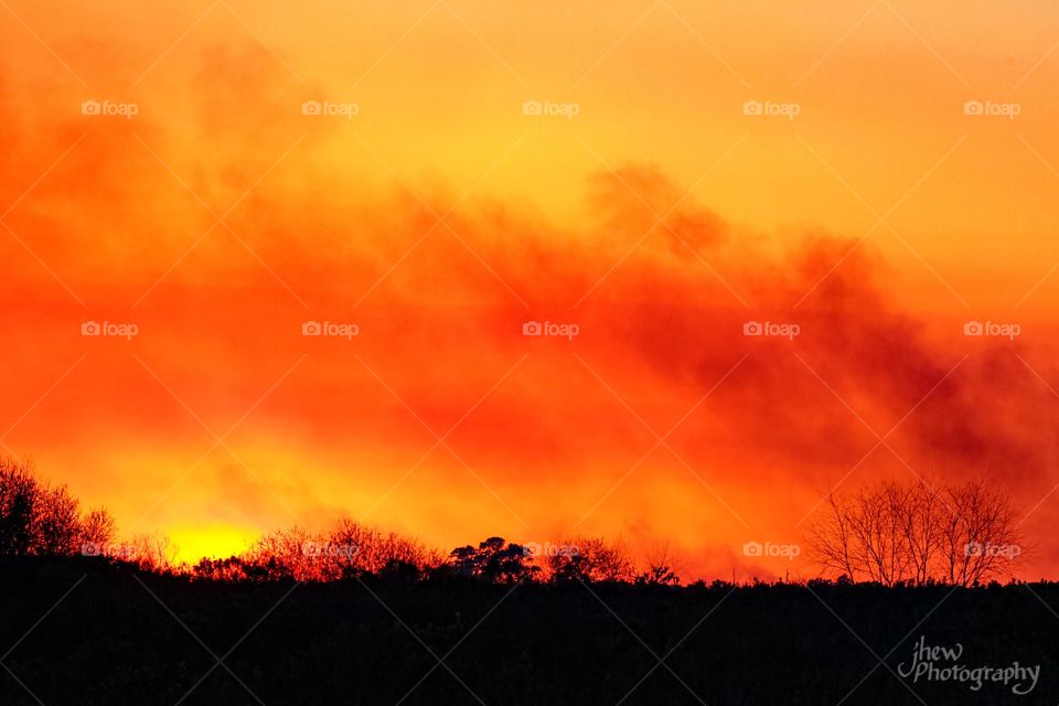 Sunset mixed with smoke from a controlled burn