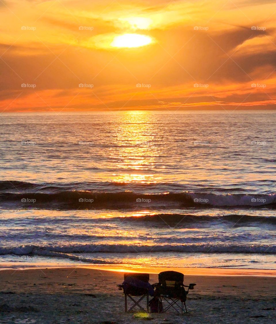 Empty chairs sit on a San Diego beach waiting for their owners to come occupy them in order to witness a stunning sunset