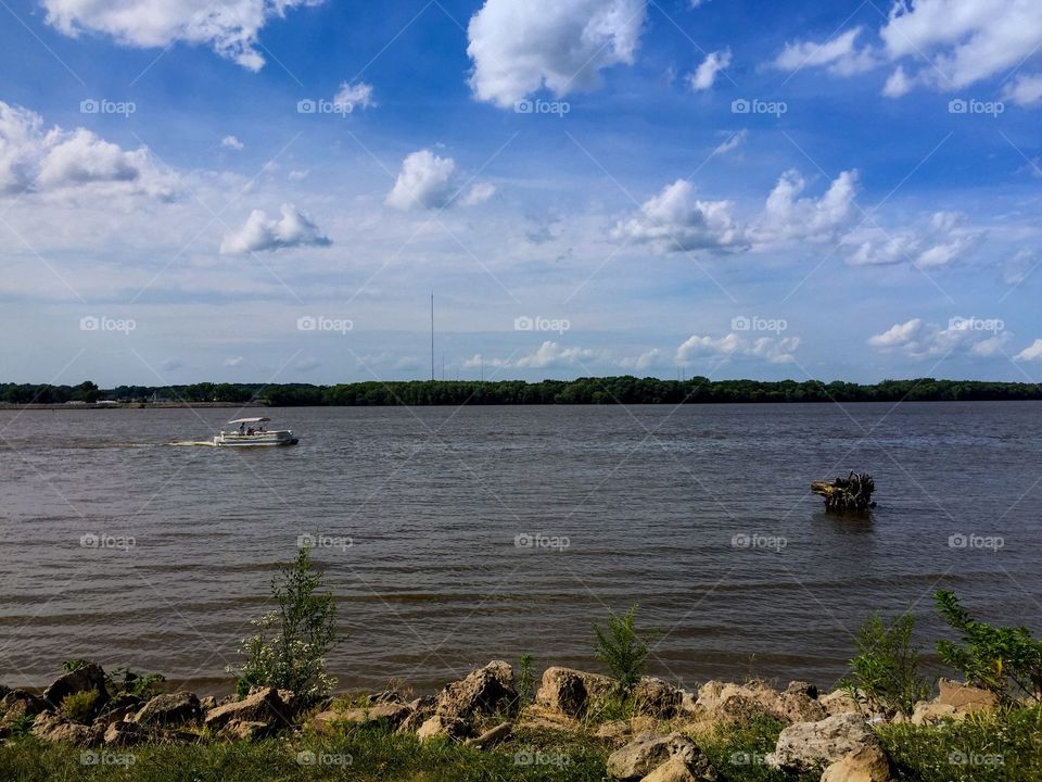 Enjoy the nice view along the Mississippi River! The sun is out, the clouds look fantastic, and the boats are out. This is on the Illinois side of the Quad Cities river drive looking at the Iowa border. 