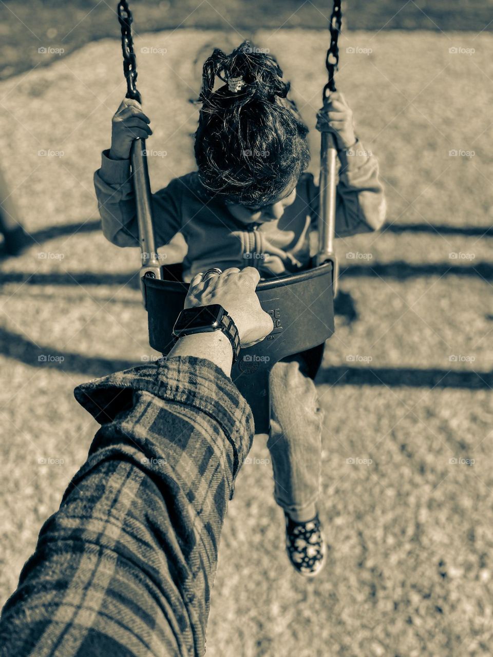 Mother swinging little girl at the park, little girl on a swing, hair is the best accessory, little girl with cute curly hair, little girl with pony tail 