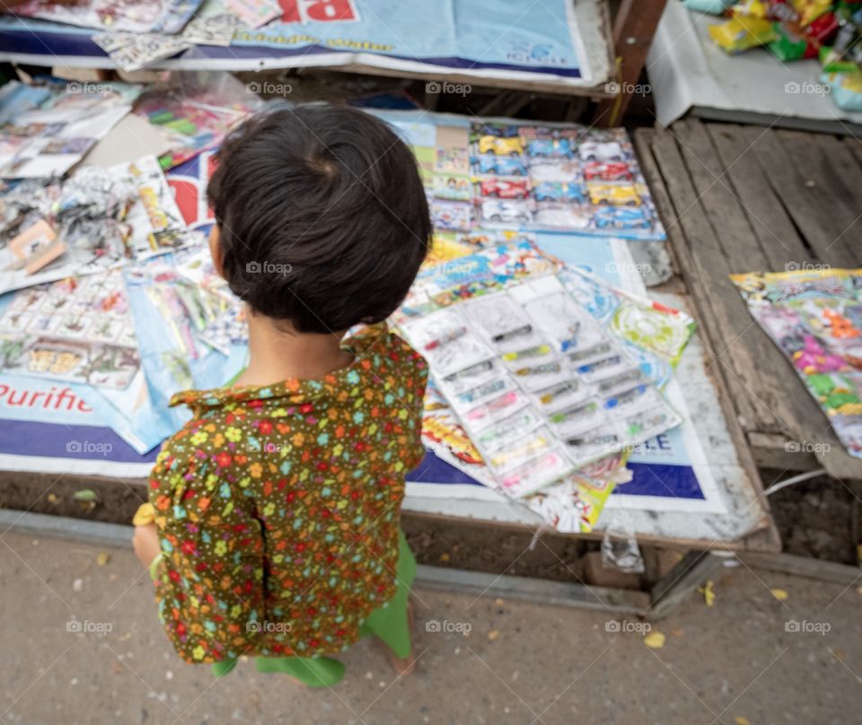 Myanmar student is selecting toys at local shop