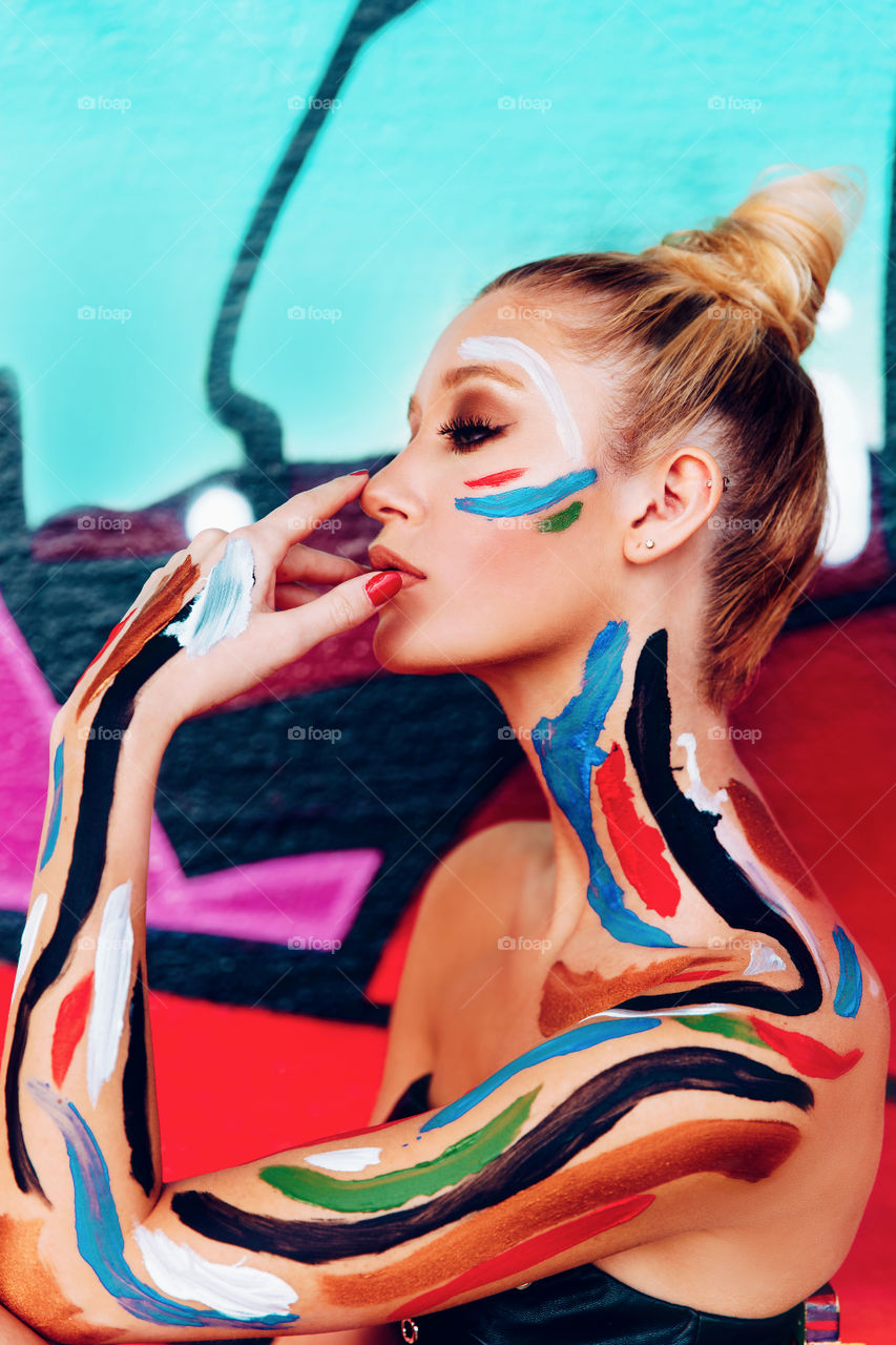 A Splash of colors , a beautiful model and a graffiti wall found in an abandoned building downtown Houston ,makes for great art .