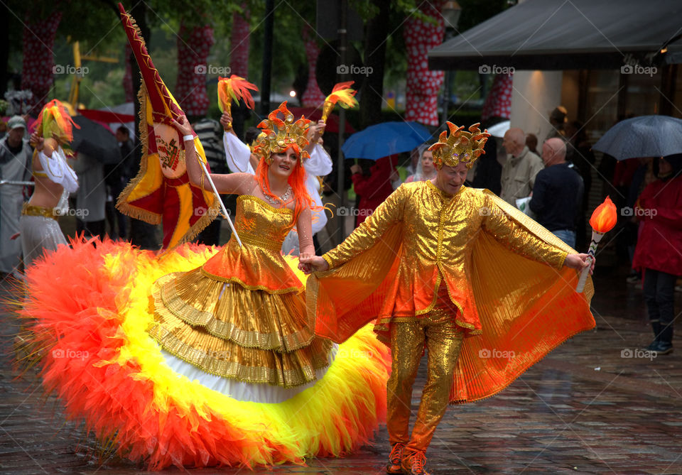 Helsinki, Finland – June 18, 2016: Unidentified dancers and performers dancing in heavy rain in Samba procession at the 26th Helsinki Samba Carnaval in Helsinki, Finland on Saturday June 18th, 2016 on Pohjoisesplanadi street. Different Samba schools compete against each other in parade around down town Helsinki.