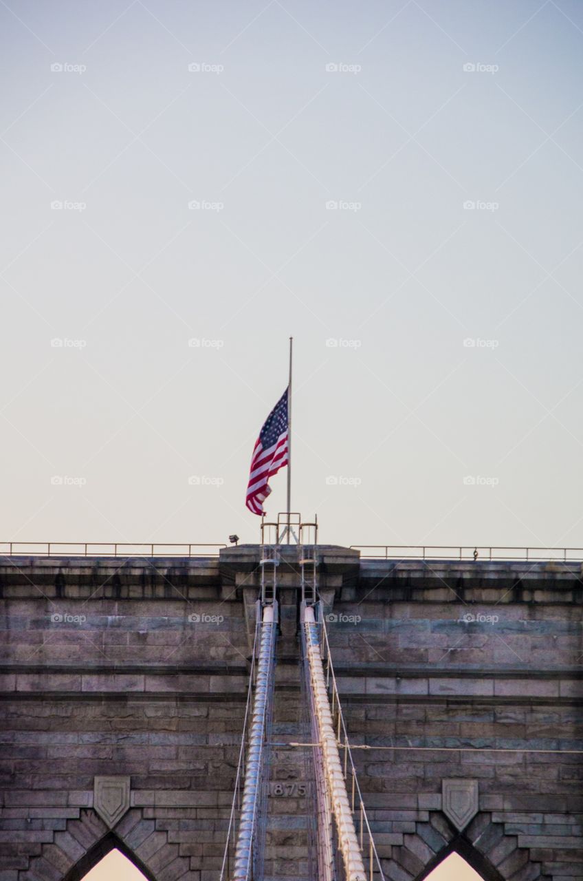 Half Mast over Brooklyn Bridge . American Flag atop the Brooklyn Bridge 