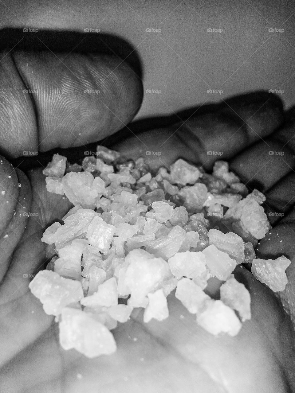 close up of coarse sea salt held in the hand