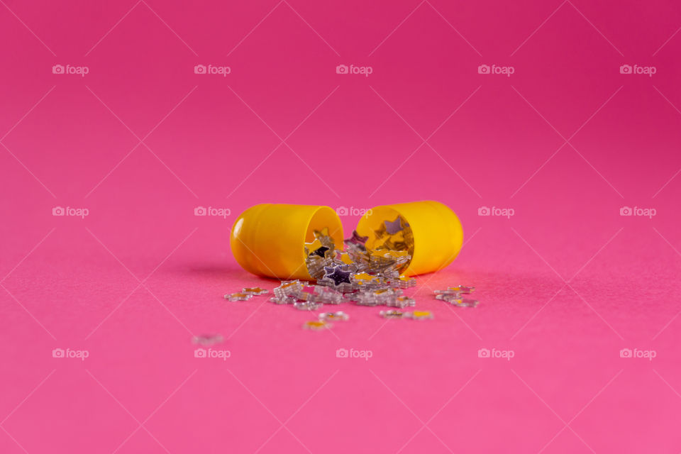 Creative pill open with little stars coming from it