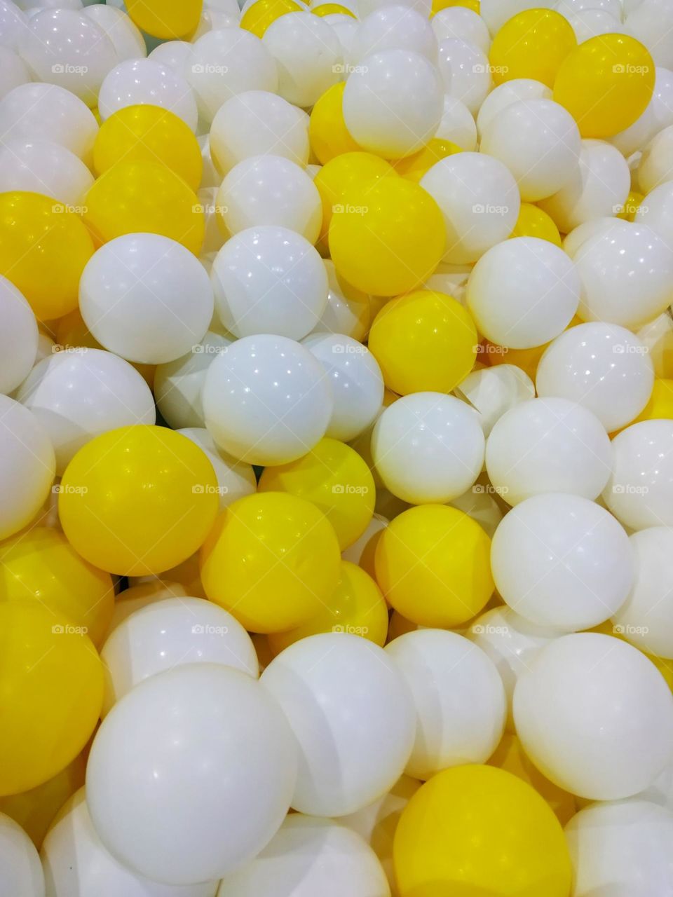 A collection of yellow and white balls