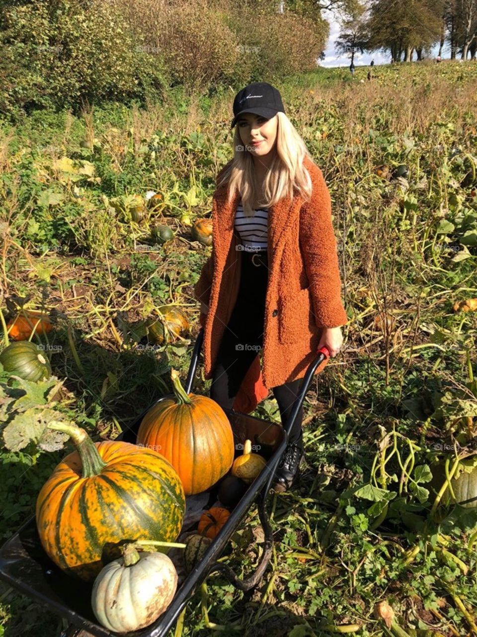 Young lady pumpkin picking 