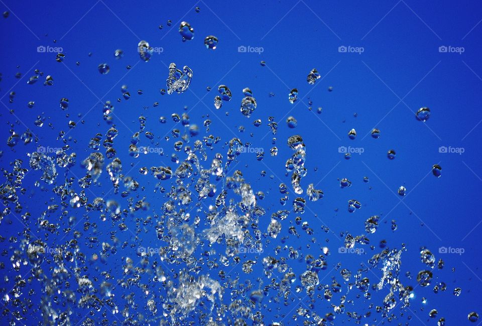 water in motion - water drops on the blue sky background