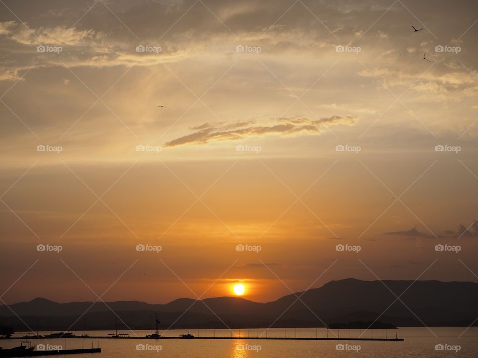 Deep sunset over Corfu Town Old Harbour, Greece