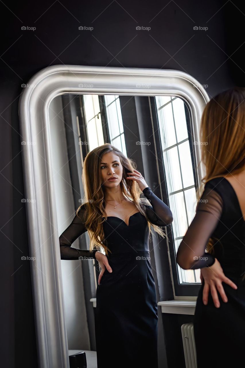 Beautiful girl reflected in the mirror