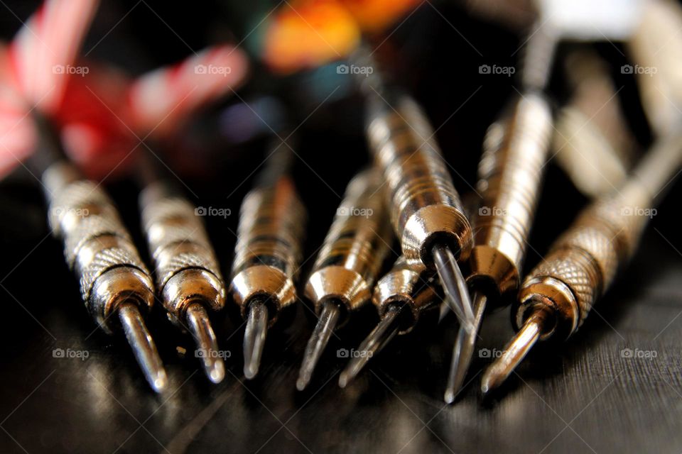 Close-up of darts lying on a table