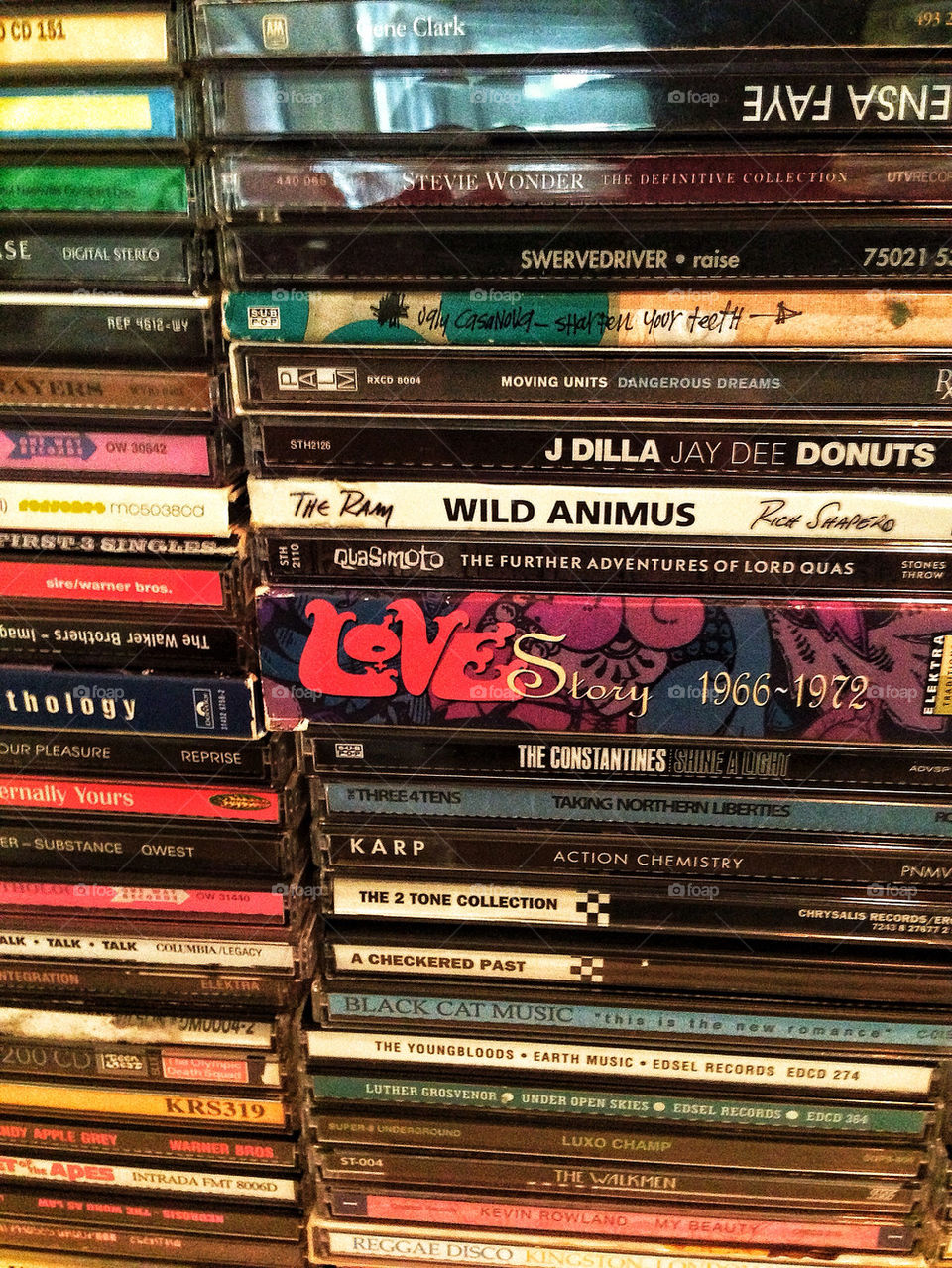 Stack of vintage compact discs in a hipster music collection