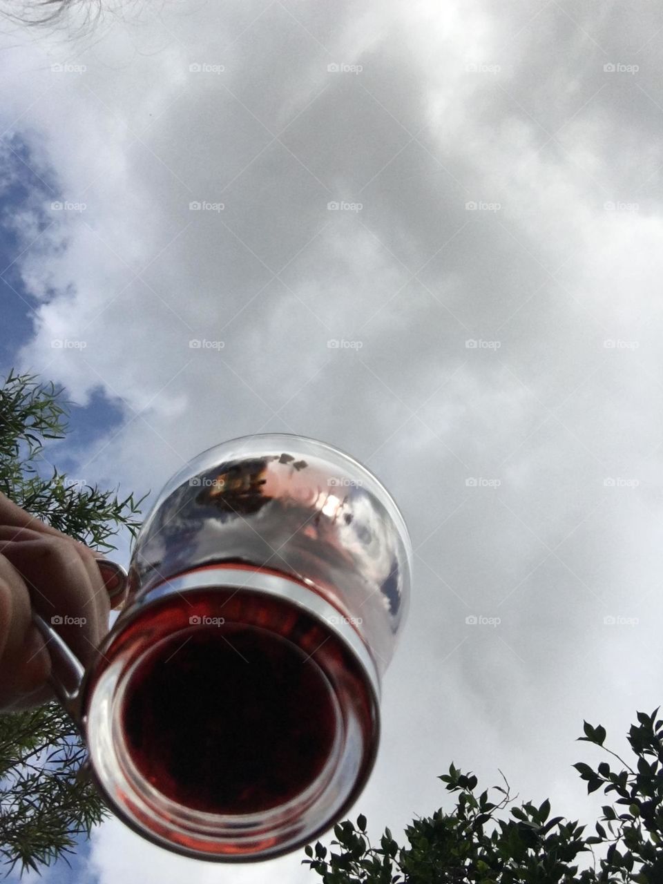 Picking up my cup of tea- magenta coloured tea under the approaching clouds. 