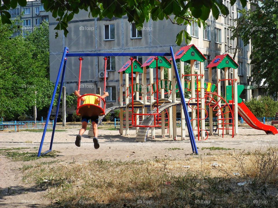 child riding on a swing