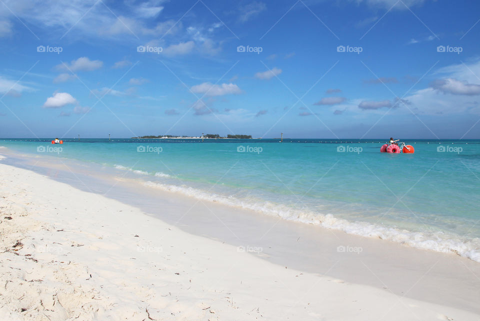 Tourists on tricycle in sea