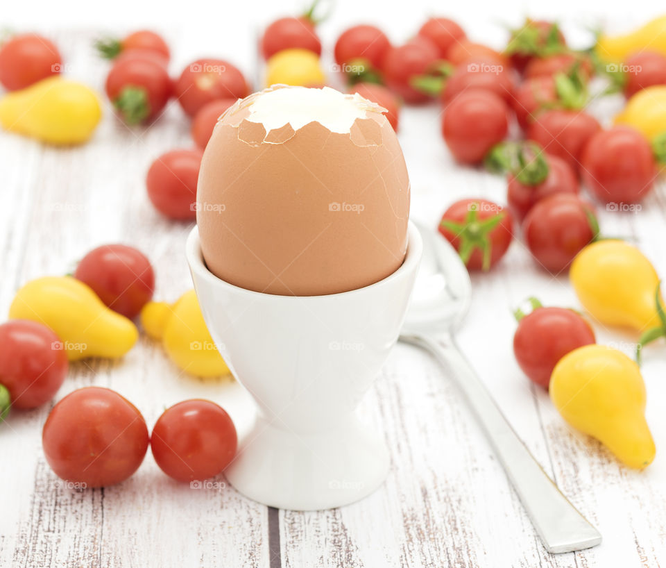 Boiled egg with red cherry tomatoes