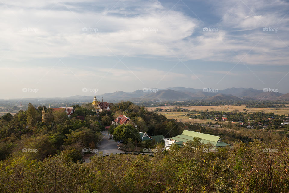 Temple pagoda on the hill with mountain in the background in Chiang Mai Thailand 