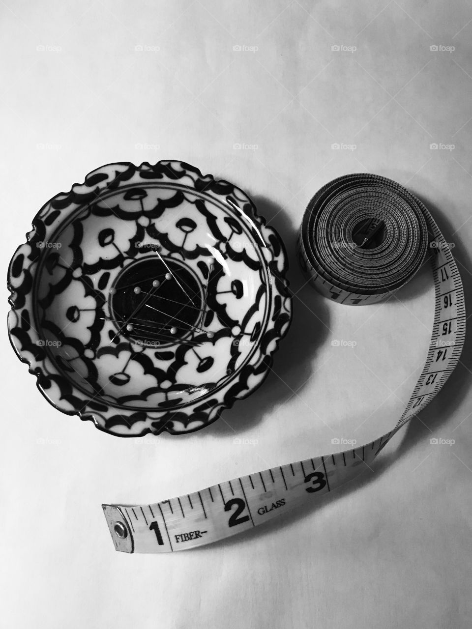 Black and white pins and measuring tape