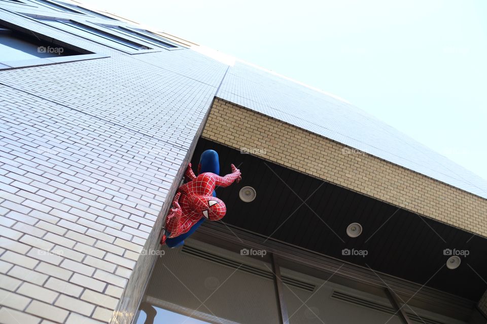 spiderman mannequin going down a building