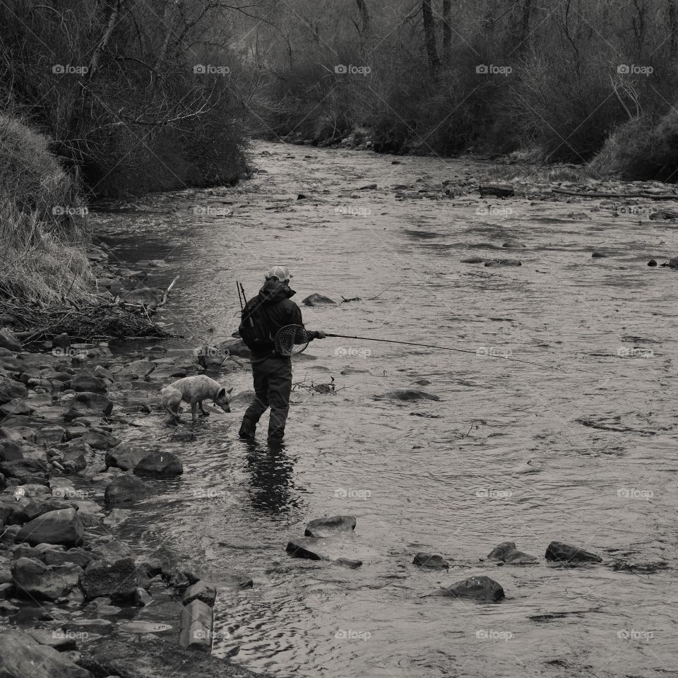 High angle view of fisherman with dog
