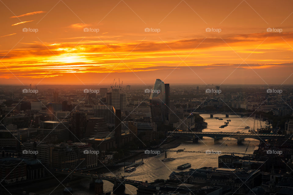 Autumn sunset over London with view at the busy Thames River with bridges. London. UK.