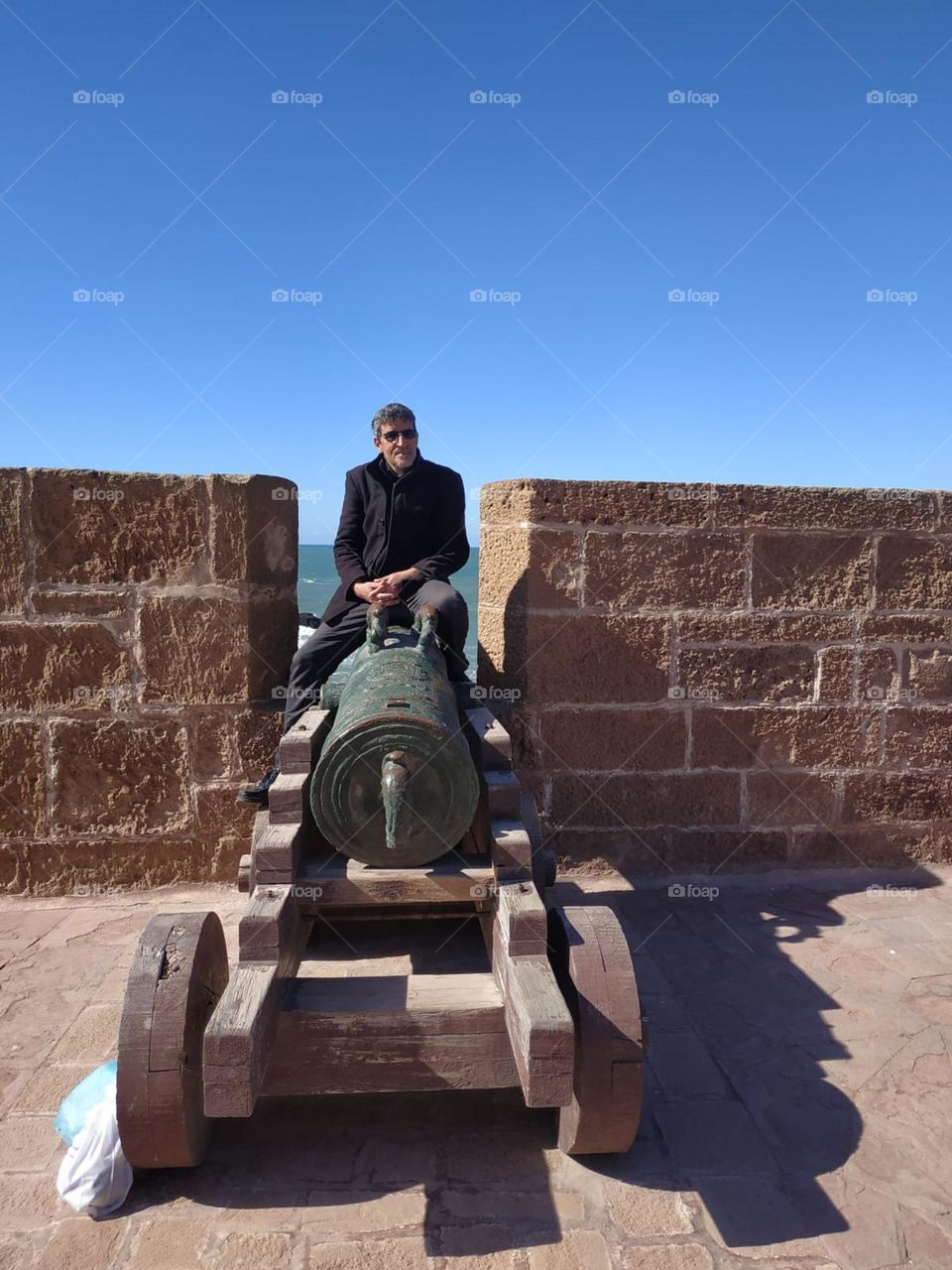 Im sitting on an ancient cannon at essaouira city in Morocco.