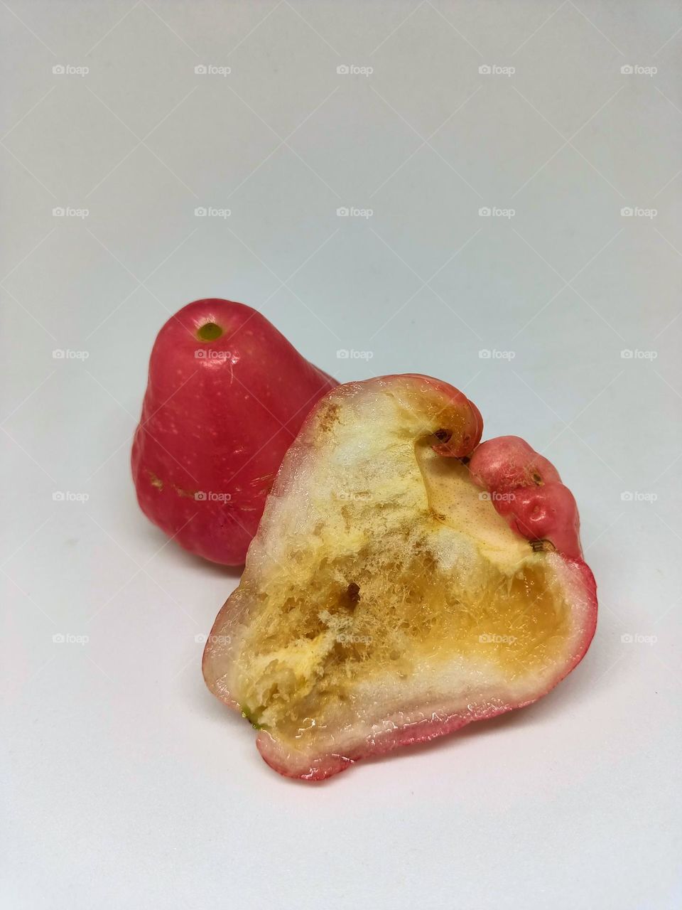 Close-up rotten and wormy of wax apple isolated on
white background. Selective focus, underexposed, blurry, low light, too
soft