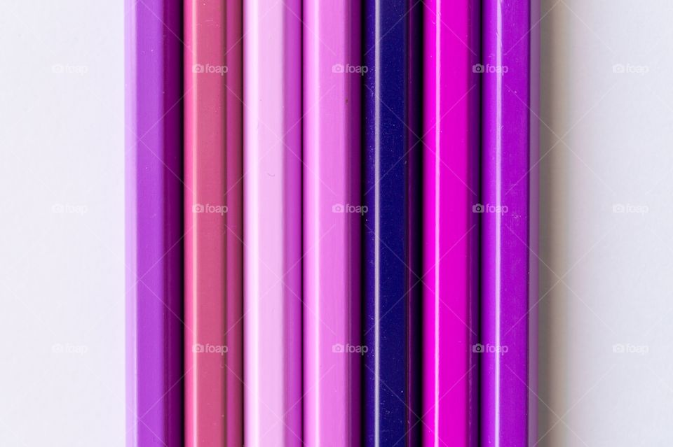 Close-up of purple pencils against white background