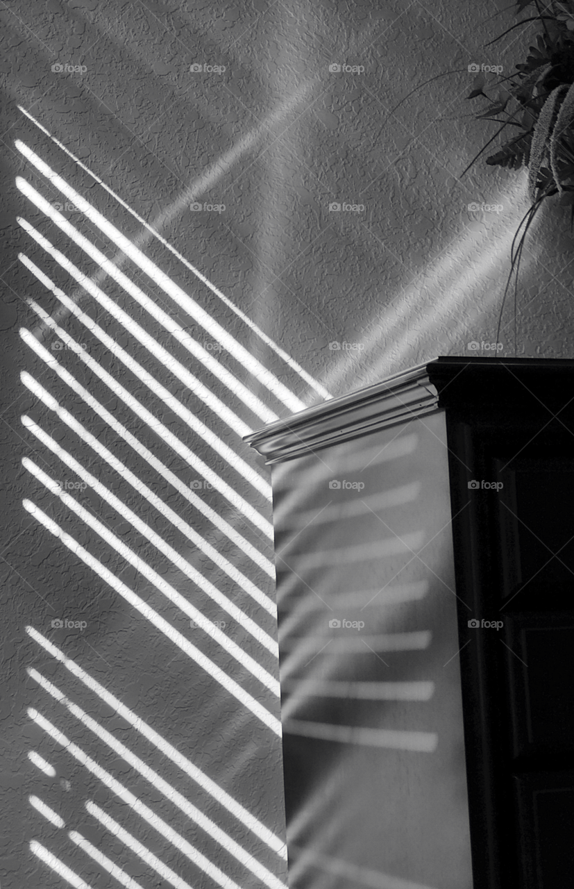  Light rays and shadows paint the room in unique diagonal lines.