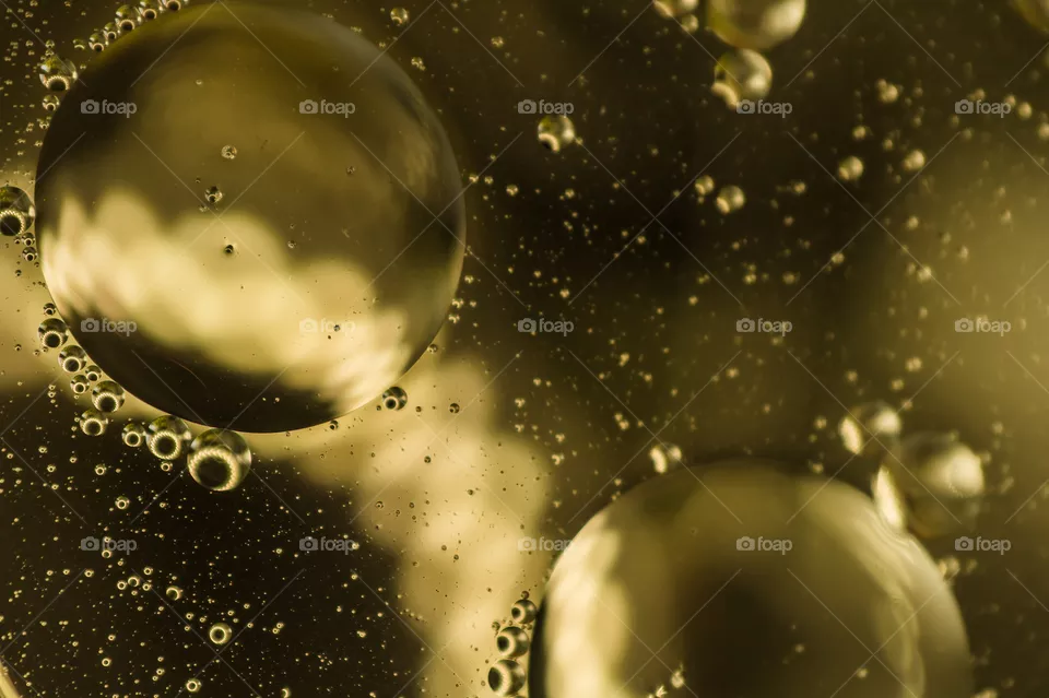 Small bubbles of vegetable oil in water close-up.