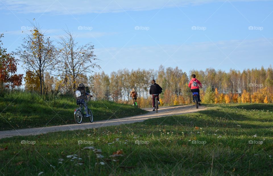 people riding on a bikes autumn beautiful landscape