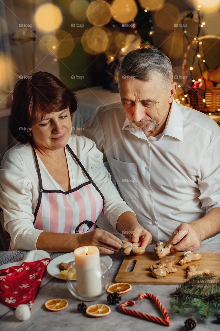 Couple in love, senior cooking cookies new year’s 