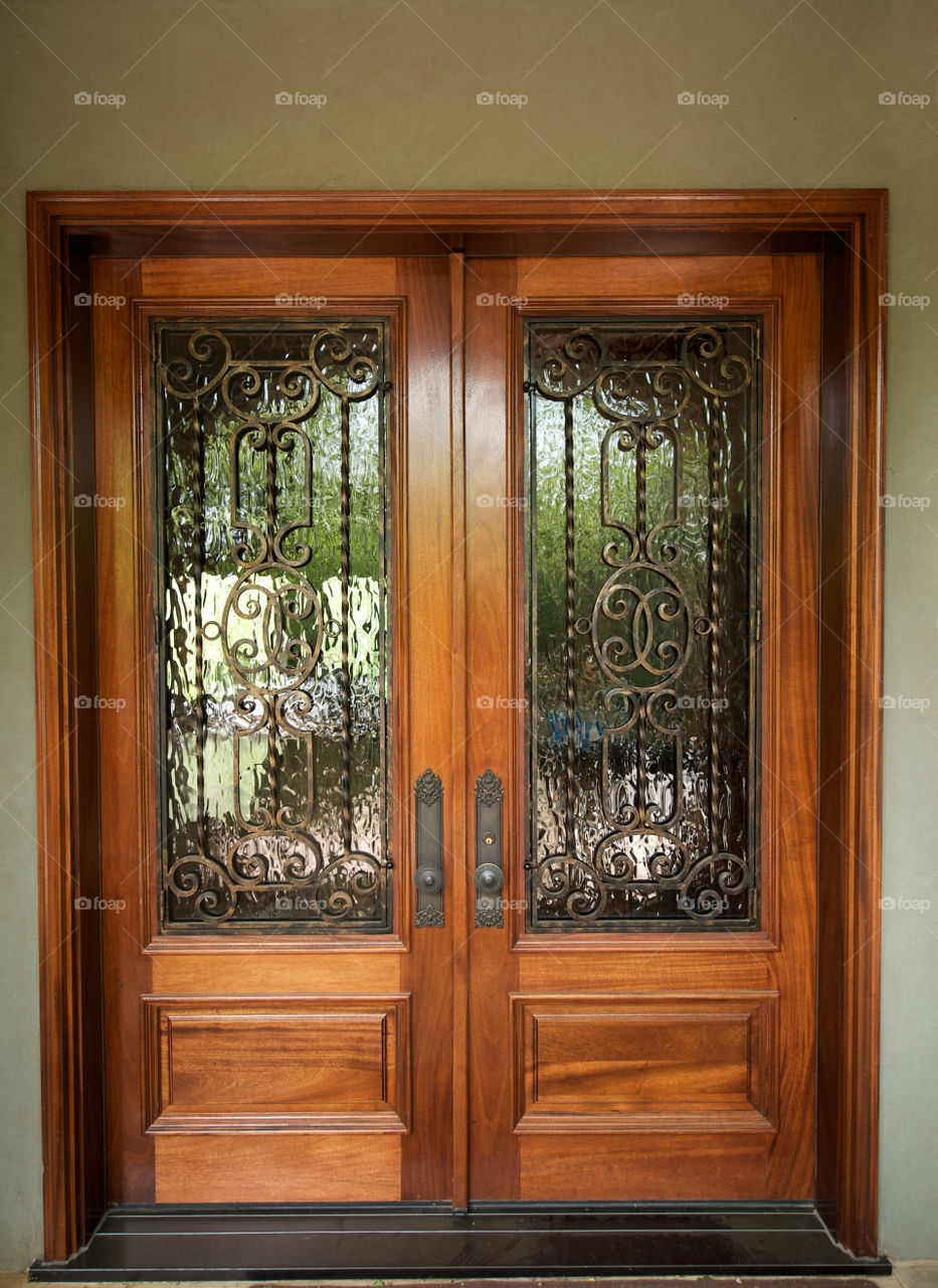 Beautiful wood doors with iron and glass