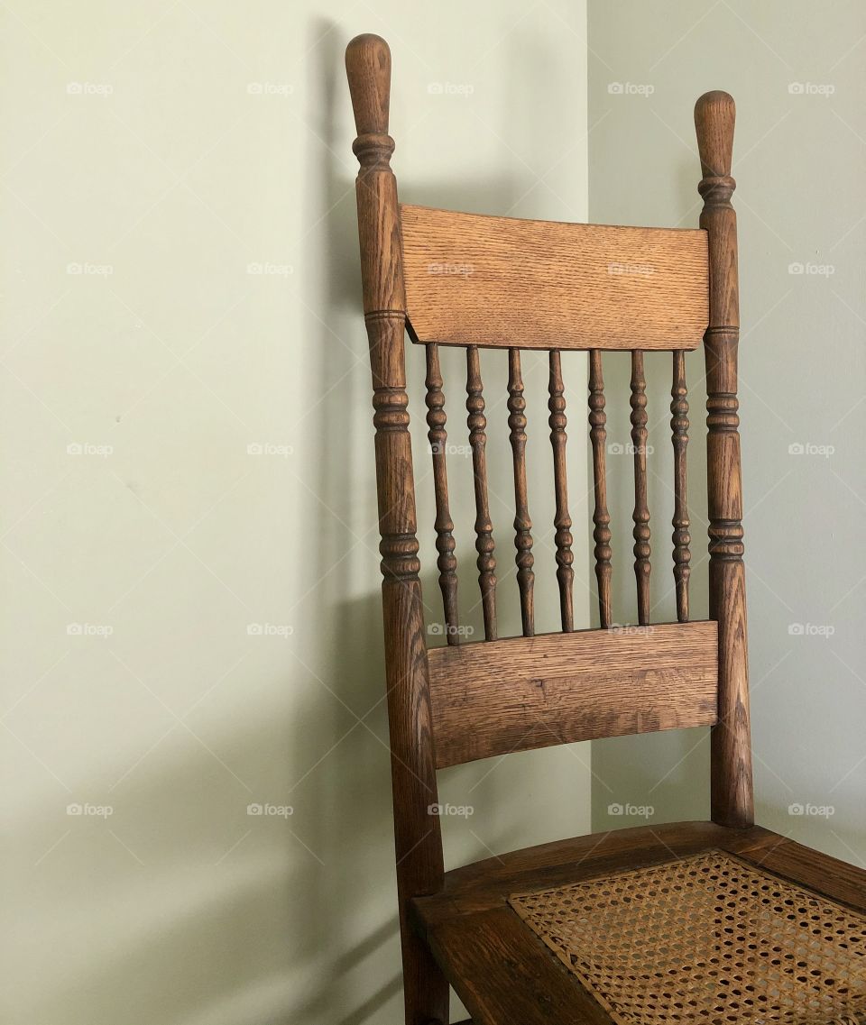 Antique wooden chair in corner 