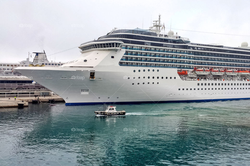 Port pilot is leading big cruiser into the port