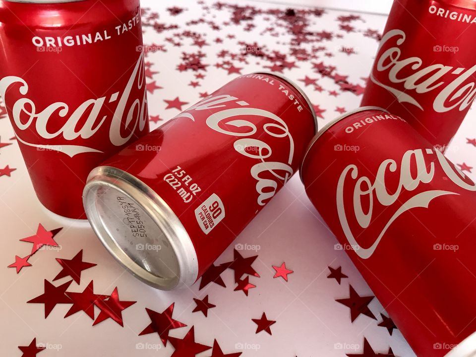 Coca Cola on a white background with red stars