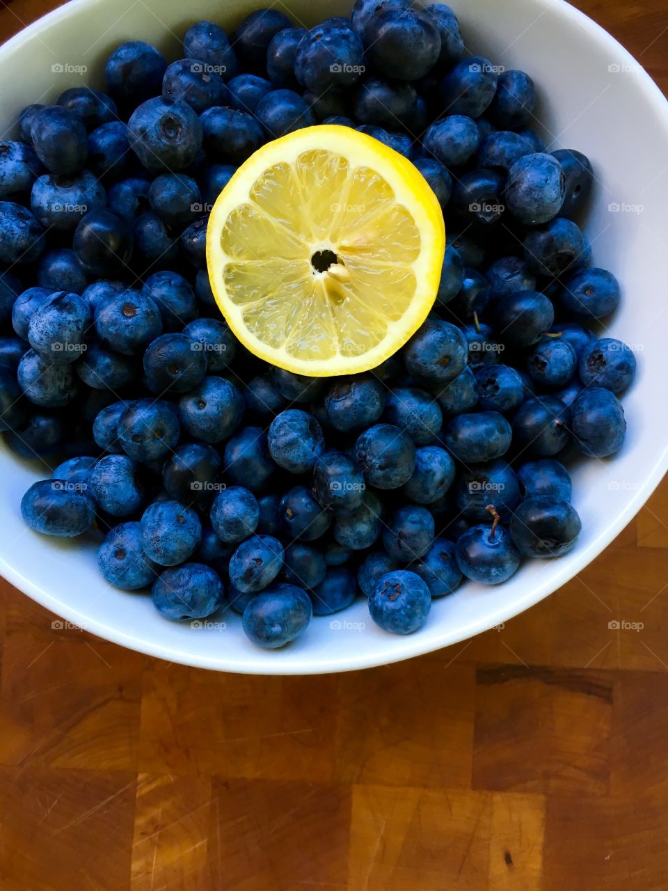 Lemon slice with blueberries on a plate