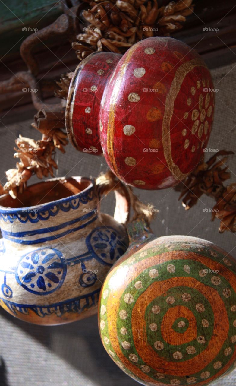 Hand-made and painted colourful pottery hanging on display 