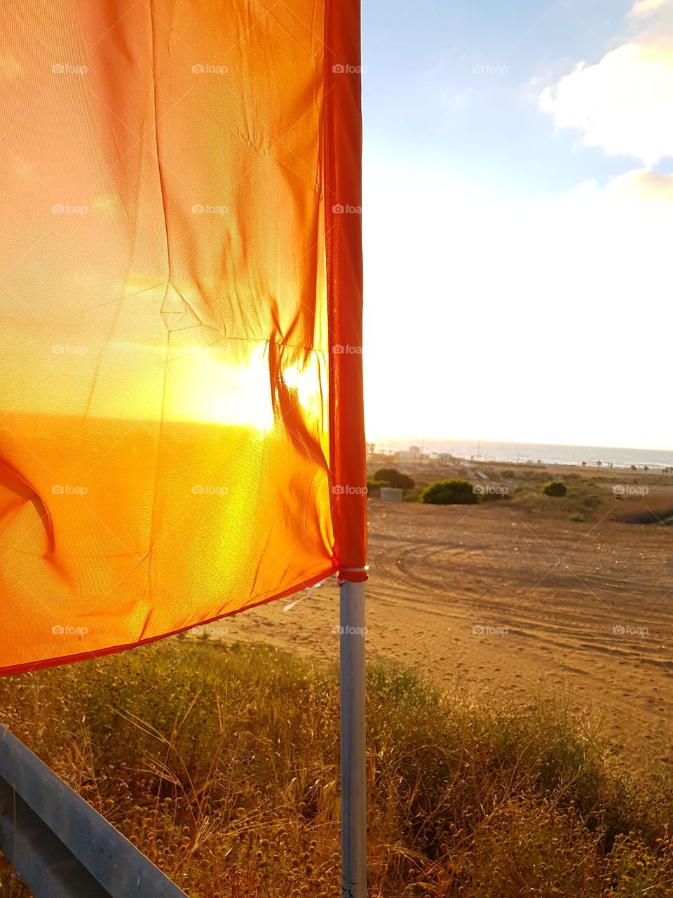 Orange flag and sunset