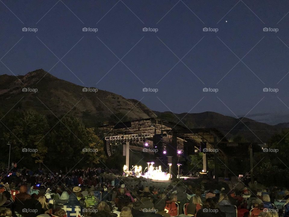 A summer concert crowd enjoys a live show at an amphitheater in Salt Lake City, Utah 